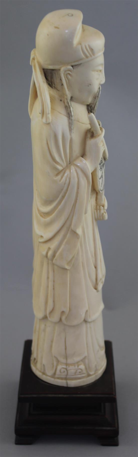 A large Chinese ivory figure of a scholar, early 20th century, 26.5cm, wood stand